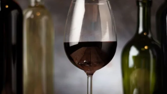 La botella de vidrio en el centro de la escena (la industria vitivinícola depende de su envase)